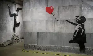 Dzieło Banksy'ego: dziewczynka sięga po czerwone serce, obok gimnastyczka na rękach. Kim jest Banksy? Tajemniczy artysta.