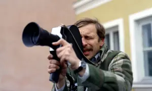 Jerzy Stuhr w filmie Kieślowskiego, z kamerą w ręku, skupiony na kadrze.
