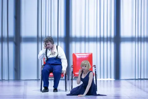 Mężczyzna i kobieta na scenie, w dramatycznych pozach, podczas jednego z Warlikowski spektakli.