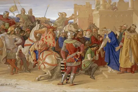 Rycerze Okrągłego Stołu w zbrojach i z tarczami, wśród nich królowie i damy, przygotowują się do ceremonii.