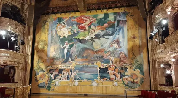 Teatr mój widzę ogromny, z bogato zdobionymi lożami i wielkim, barwnym malowidłem na scenie, przedstawiającym sceny z mitologii.