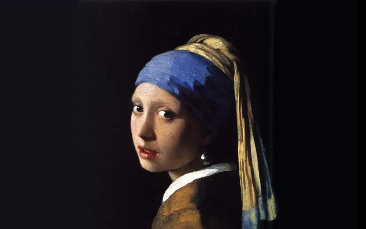 Dziewczyna z perłą Vermeer, z niebieską chustą na głowie i spojrzeniem pełnym tajemnicy, przyciąga wzrok.
