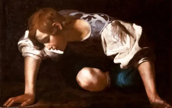 Obraz Caravaggia: młody mężczyzna pochyla się nad wodą, wpatrzony w swoje odbicie. To narcyz, uwięziony w miłości własnej.